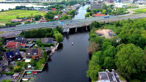 High angle horizontal aerial drone video clip of river canal, boat, highway Vídeos de archivo 342995708