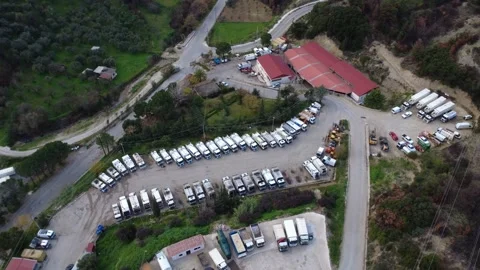 High angle industrial fleet storage and heavy service vehicle facility near city Stock Footage 344096795