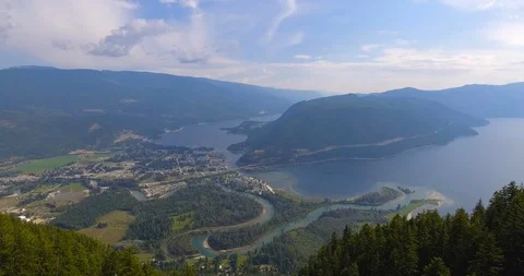 High angle of large mountains and beautiful lakes with heavily forested areas Vídeos de archivo 113979873