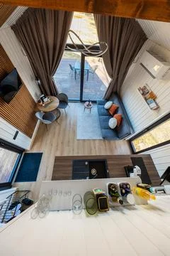 High angle loft view of Nordic tiny home with deck and kitchenette Stock Photos