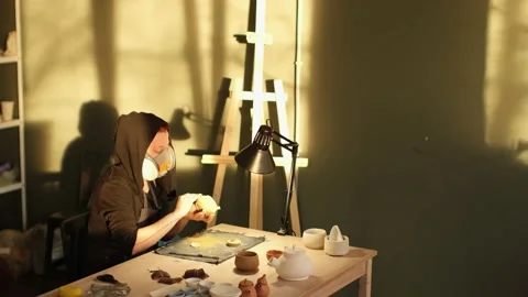 High angle long shot of female ceramic artist making utensils for tea in studio Stock Footage 236372156
