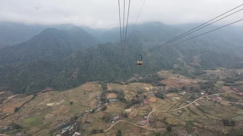 High angle look down from cable car at village and fields in Sapa Видео 295086557