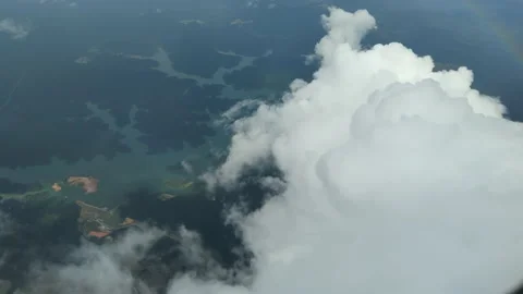 High angle look down clouds and land mass Stock Footage 224588447