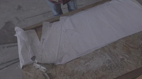 High Angle of man slamming construction plans onto a desk Stock Footage 102125334