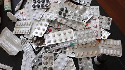 High angle, medication lying on table, dozens of pills, Stock Footage 128525235
