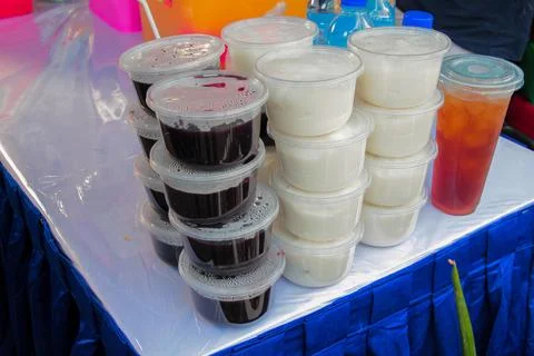 High-angle medium shot showing plastic cups stacked with Bubur Ketan Hitam (B Stock Photos