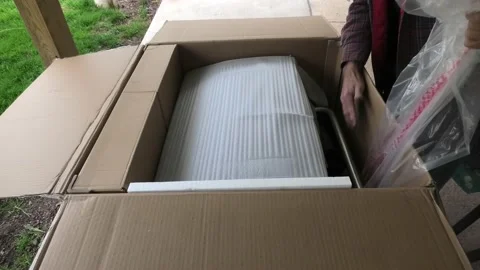 A High Angle Medium Shot of Unpackaging a Propane Gas Grill Stock-Footage 192606040
