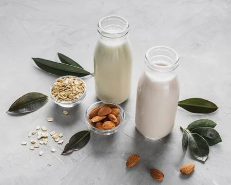High angle milk bottles with almonds oats Stock Photos