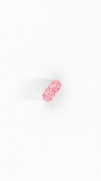 High angle minimalist studio shot of a single pink textured medicinal table.. Stock Photos