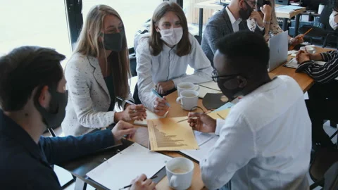 High angle multiethnic creative start-up business people wear masks working at Stock Footage 137743904