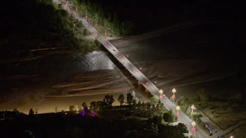 High-Angle Night Aerial View of Mengbulake Bridge and Tekes River 動画素材 343561554