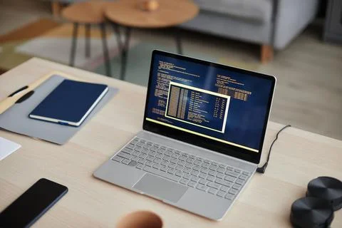 High Angle Open Laptop with Code Lines at Home Office Desk Foto stock