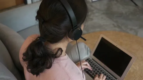 High angle, over the shoulder shot of Asian call center working at home Stock Footage 205510386