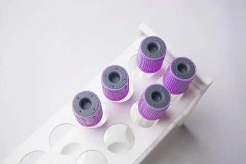 High-angle, overhead shot of four empty medical blood collection tubes with.. Stock Photos