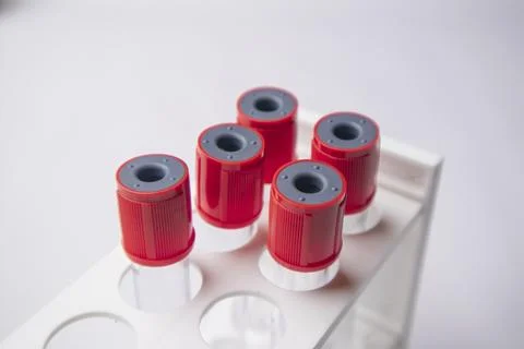 High-angle, overhead shot of four empty medical blood collection tubes with.. Stock Photos