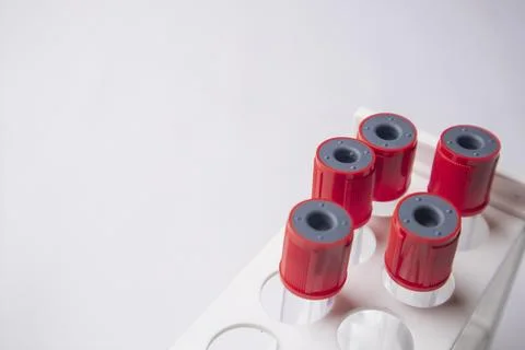 High-angle, overhead shot of four empty medical blood collection tubes with.. Stock Photos