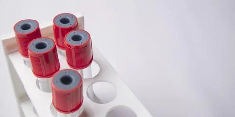 High-angle, overhead shot of four empty medical blood collection tubes with.. Stock Photos
