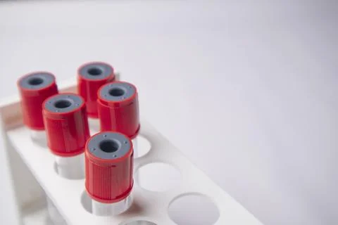 High-angle, overhead shot of four empty medical blood collection tubes with.. Stock Photos