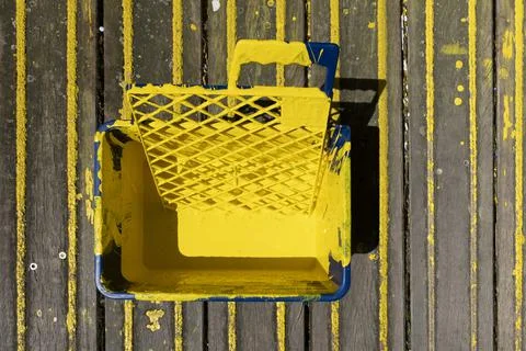 High angle of paint roller in tray with paint can on wood floor Stock Photos