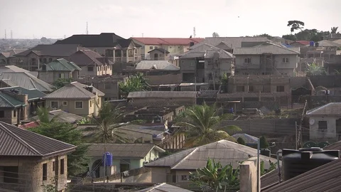 High angle pan of rooftops in residential neighborhood of Lagos, Nigeria Stock Footage 86761003