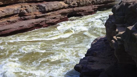 High-Angle Pan of Waterfall and Yellow River Rapids at Hukou Waterfall Tourist Stockbeeldmateriaal 335434912