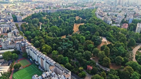 High angle panning drone view of Parc des buttes chaumont in Paris cityscape at Stock-Footage 341075075