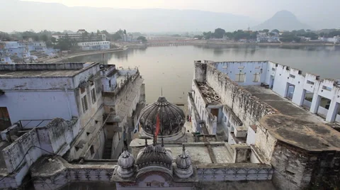 High-Angle Panning Upwards Ghat Entrance and Pushkar Lake at Dawn with Birds Stock Footage 33537190
