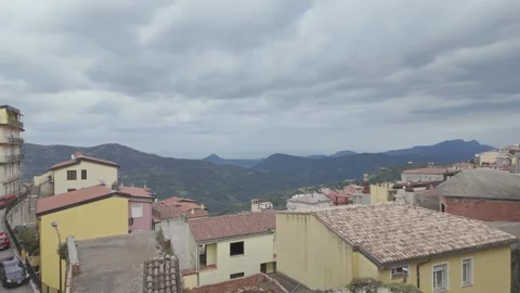 High Angle Panning View of Baunei Mountain Village and Tiled Rooftops Near Stock Footage 337725228
