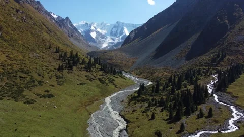 High angle panoramic view of glacial river valley under snow-capped peaks Stock Footage 335647663