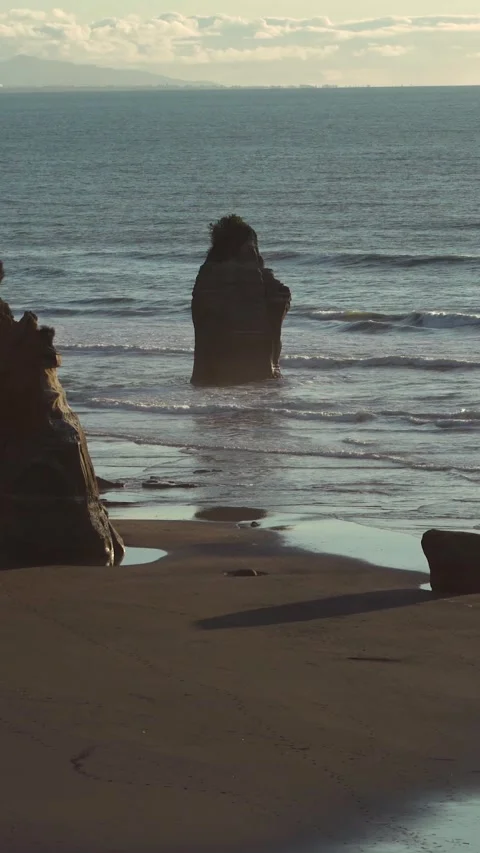 High angle panoramic view of man walking by the beach surrounded by big roc.. Stock Footage 289103174
