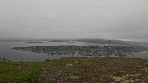 High angle panoramic view of Tromso city island with red warning beacon on right 動画素材 341697319