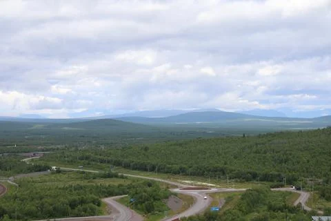 High-angle panoramic view of winding E10 highway roads and roundabout passing Stock Photos