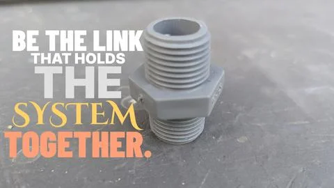 A high angle perspective displays a grey plastic threaded nipple pipe fitti.. Stock Photos