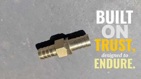 A high angle perspective displays a solid brass hose barb coupler fitting s.. Stock Photos
