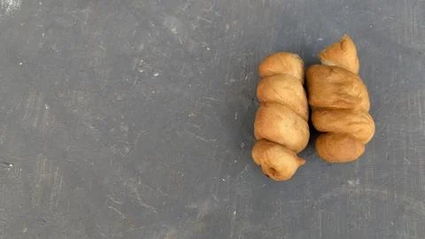 A high angle perspective displays two golden fried twisted doughnut pastrie.. Stock Photos