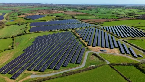 High-Angle Perspective of Large Utility-Scale Solar Power Plant on Farmland Stock Footage 343921023