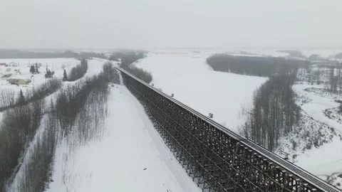 High Angle Perspective of a Long Train Trestle Bridge Covered in Snow Stock Footage 337250636