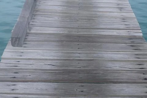 High Angle Perspective of Rustic Wooden Pier over Clear Turquoise Sea Stock Photos