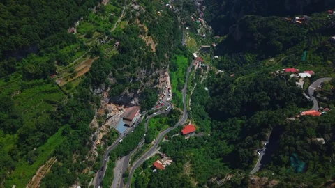 High-angle perspective showing coastal village architecture built into steep Stock Footage 348096390