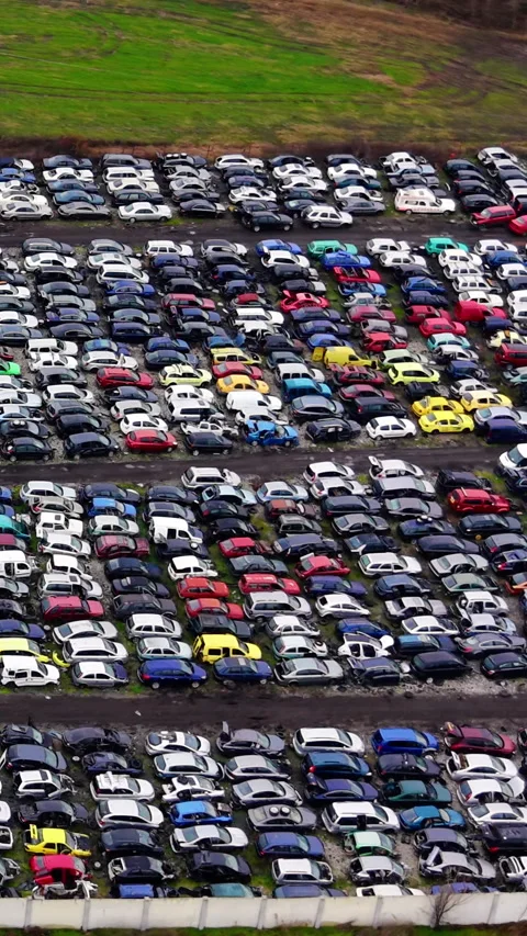 High angle perspective of vast outdoor vehicle cemetery Vertical video. Stock Footage 332347710