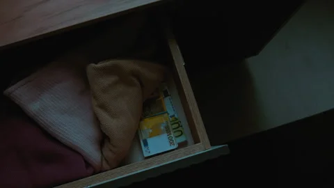 High Angle of Pieces of Clothes and Two Packs of Money in Dresser Drawer Stock Footage 292065082