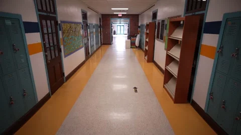 High angle push in down a long empty high school corridor hallway. Stock Footage 246925620