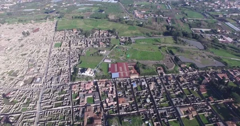 HIGH ANGLE REVERSE REVEAL SHOT OF ANCIENT POMPEII CITY RUINS AND MT VESUVIUS Stock Footage 61875004