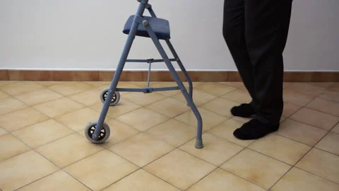 High angle on senior with black socks using a walker Stock Footage 103614223
