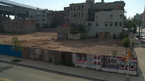 High angle shot of abandoned dirt lot with apartment buildings surrounding, day 스톡 동영상 108921307