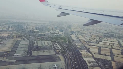 A high-angle shot from an airplane window, capturing the sprawling city of Dubai Video stock 315350015