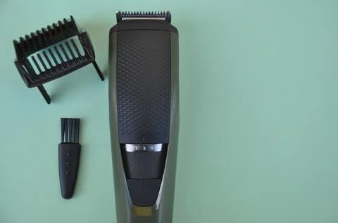 High angle shot of beard trimmer with comb and brush with negative space Stock Photos