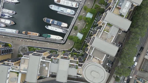 High angle shot of buildings by a harbour with docked boats. Stock Footage 246506408