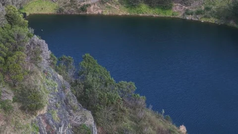 High angle shot of a calm mountain lake with steep cliffs Stock Footage 339377587