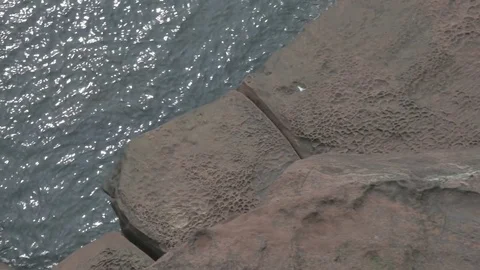 High Angle Shot of Calm Sea From Above Looking Over Sandstone Ledge Stock Footage 70806169